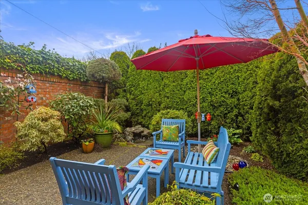 a view of an outdoor sitting area with furniture and umbrella