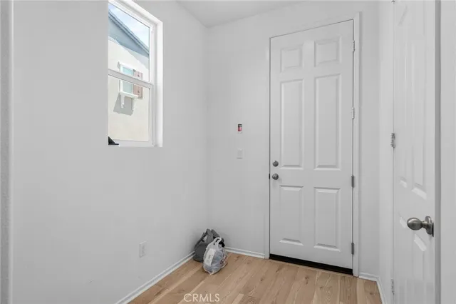 a view of a closet area with hardwood floor
