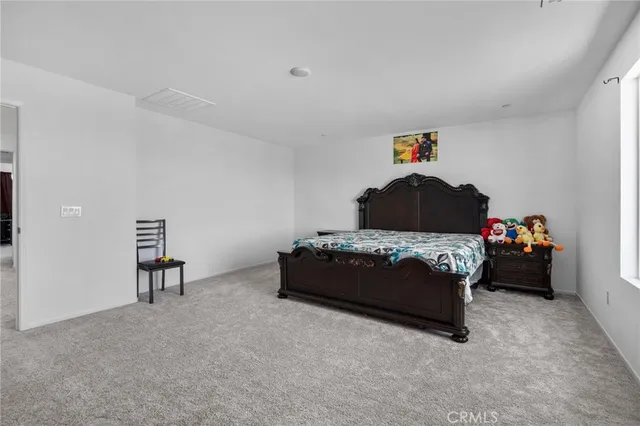 a bedroom with a bed and a chair