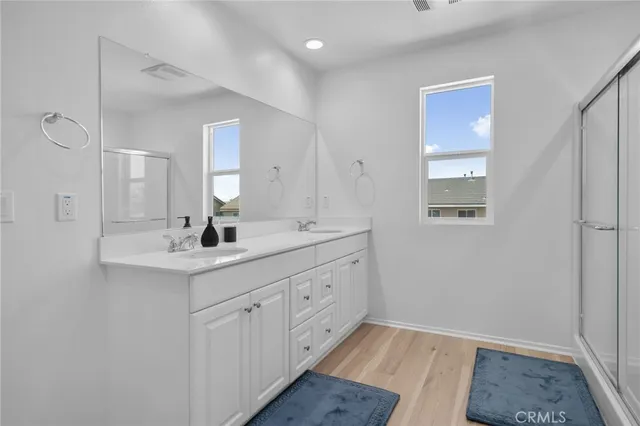 a bathroom with a double vanity sink and mirror