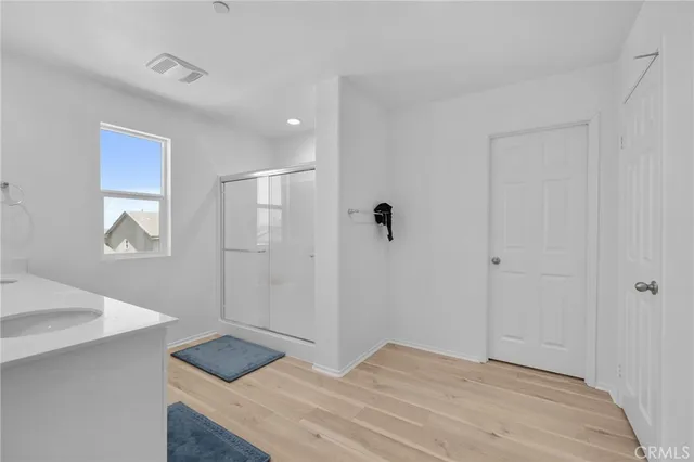 a bedroom with a sink and a mirror