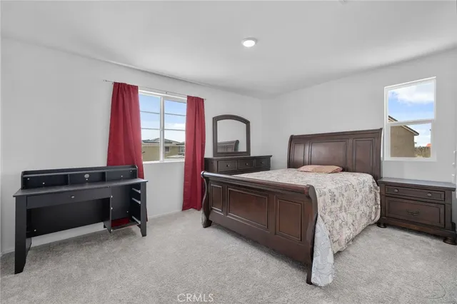 a bedroom with a bed and a fireplace