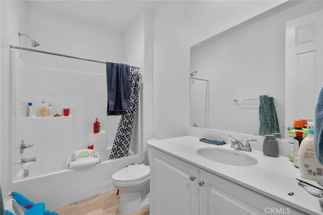 a bathroom with a sink toilet vanity and tub