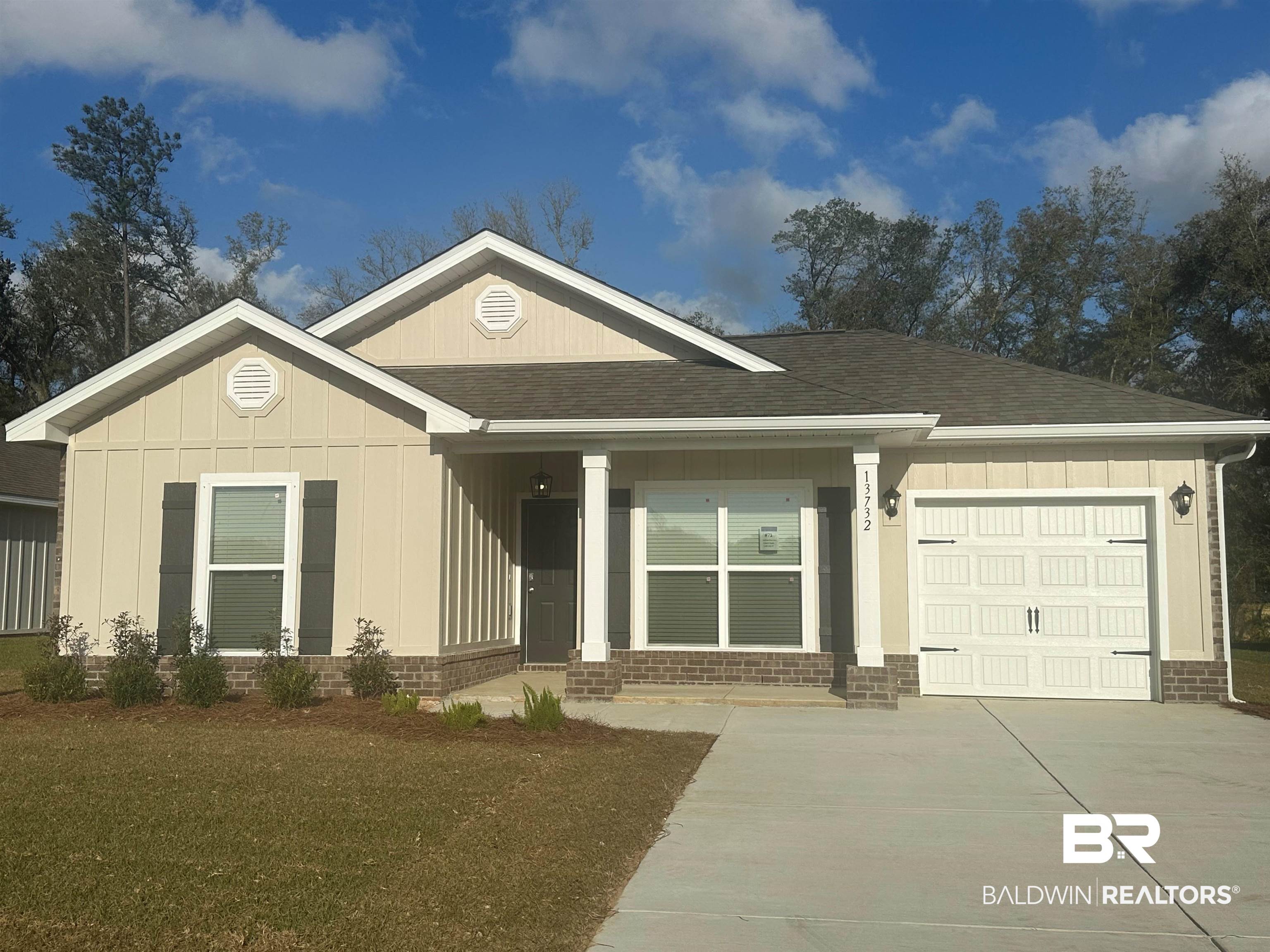 13732 Shea Circle Foley, AL 36535 - Photo 1 of 30 View of front of home with brick siding, driveway, an attached garage, and roof with shingles