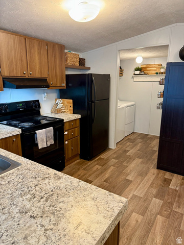 275 North Main Street, Unit 31 Centerfield, UT 84622 - Photo 1 of 13 Kitchen featuring a textured ceiling, wood finish cabinets, black appliances, and light countertops