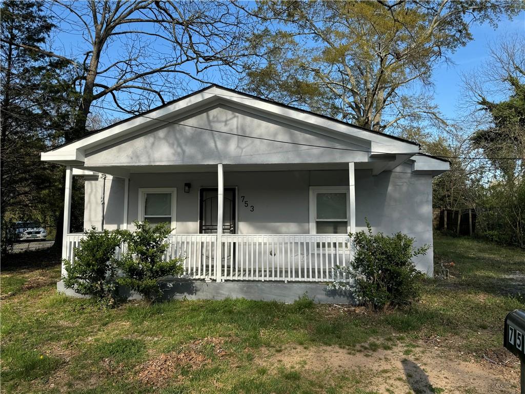 753 Second Street Stone Mountain, GA 30083 - Photo 1 of 13 a front view of a house with a garden