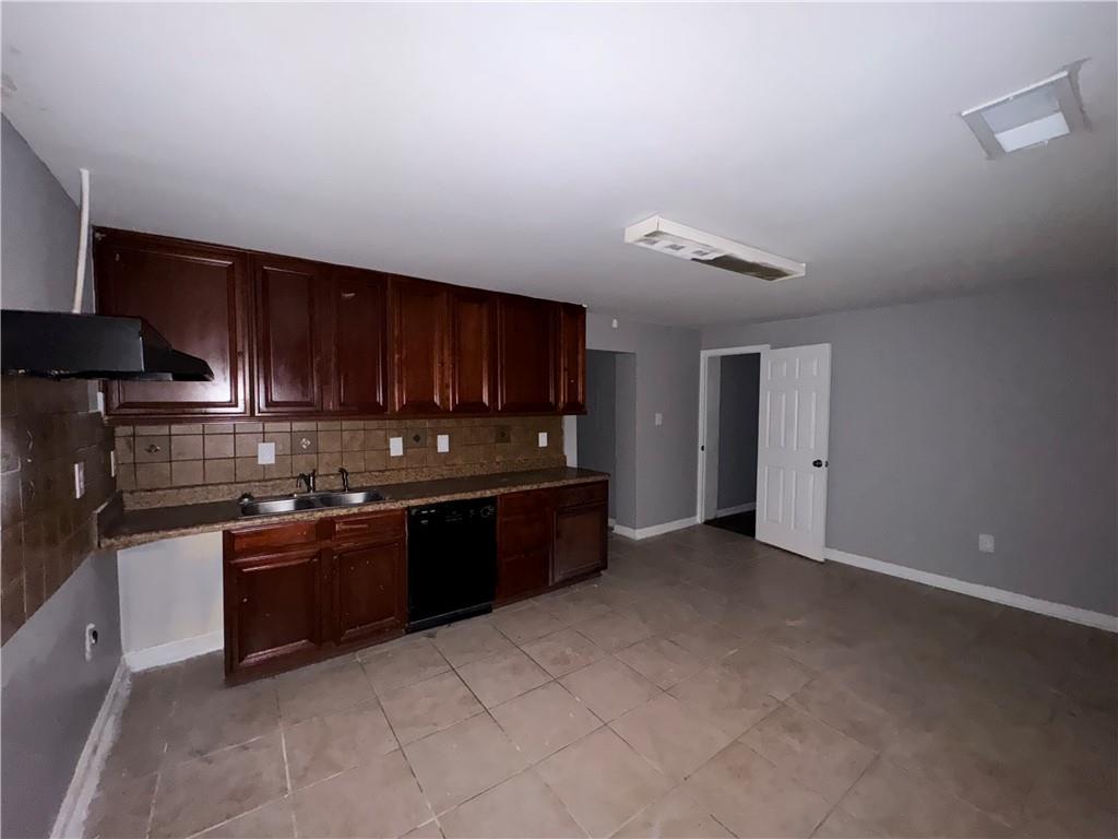 753 Second Street Stone Mountain, GA 30083 - Photo 12 of 13 a kitchen with stainless steel appliances granite countertop a stove a sink and a refrigerator