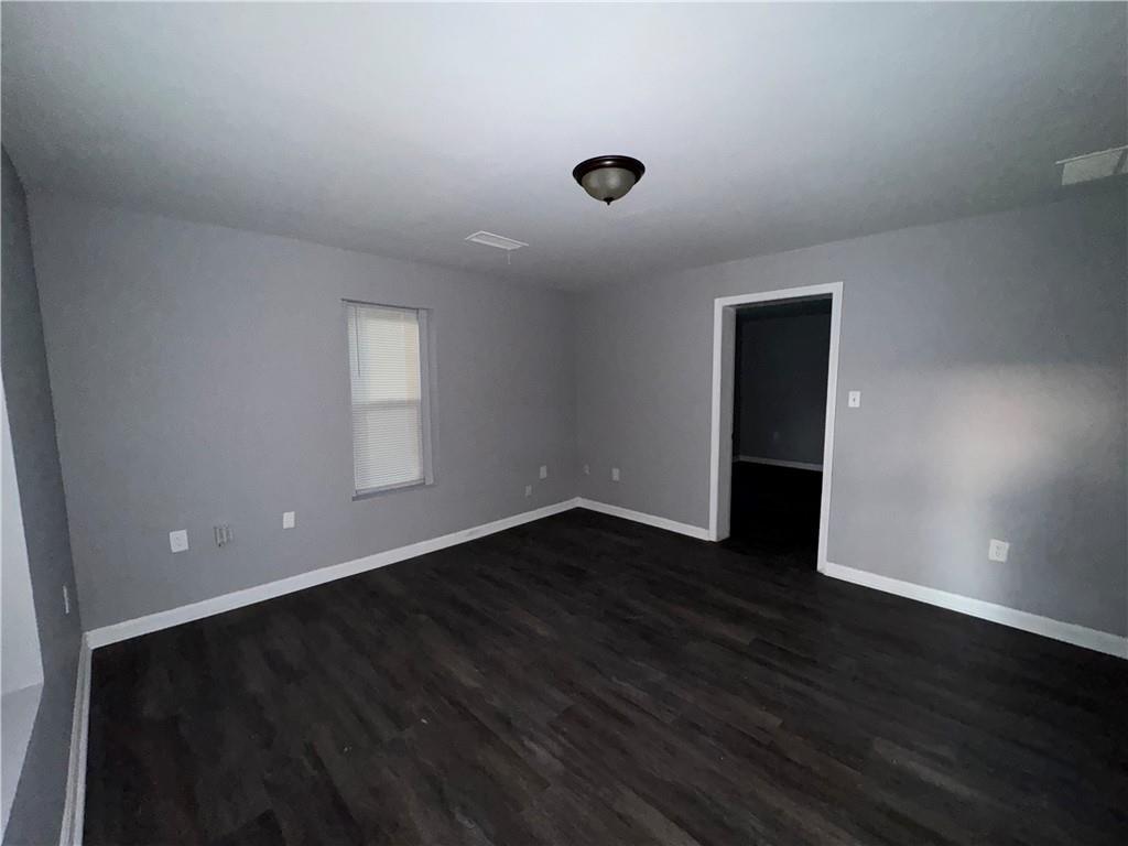 753 Second Street Stone Mountain, GA 30083 - Photo 3 of 13 a view of an empty room with wooden floor and a window
