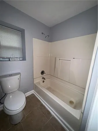 a bathroom with a toilet and a bathtub