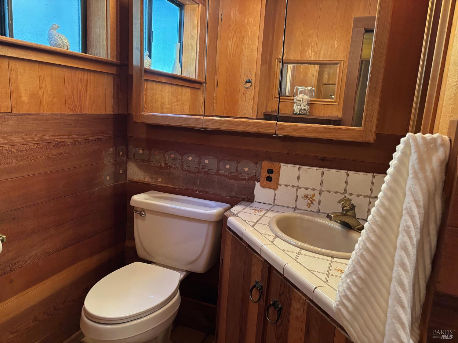 3680 Calistoga Road Santa Rosa, CA 95404 - Photo 15 of 32 a bathroom with a granite countertop toilet sink and mirror