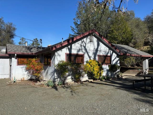 3680 Calistoga Road Santa Rosa, CA 95404 - Photo 22 of 32 a view of a house with a small yard and floor to ceiling window