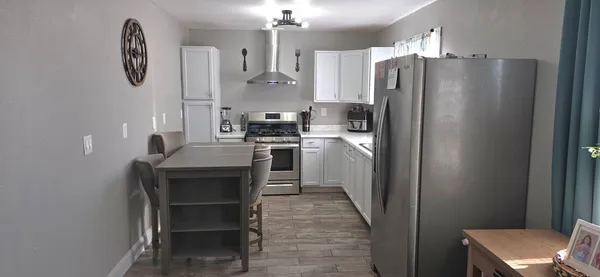 a kitchen with stainless steel appliances a refrigerator and a stove
