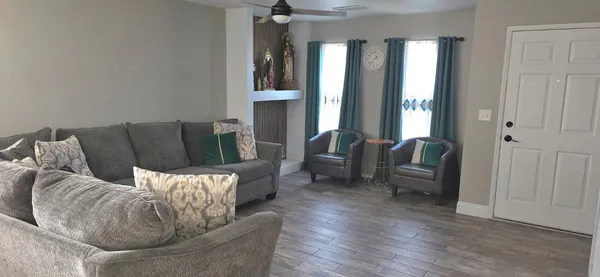 a living room with furniture and a large window