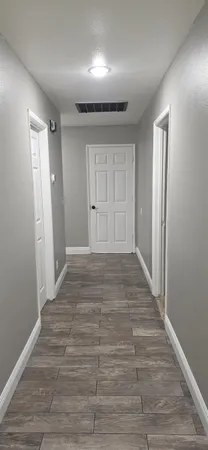 a bedroom with a bed and a flat tv screen on a dresser