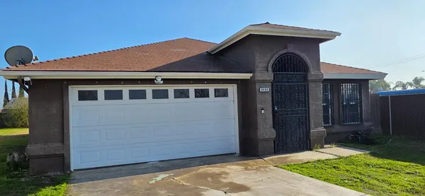 a front view of a house with garden