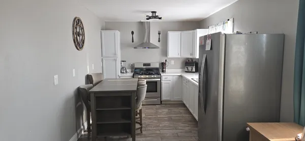 a kitchen with refrigerator cabinets and furniture