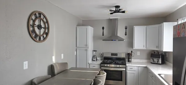 a kitchen with stainless steel appliances a stove a sink and a refrigerator