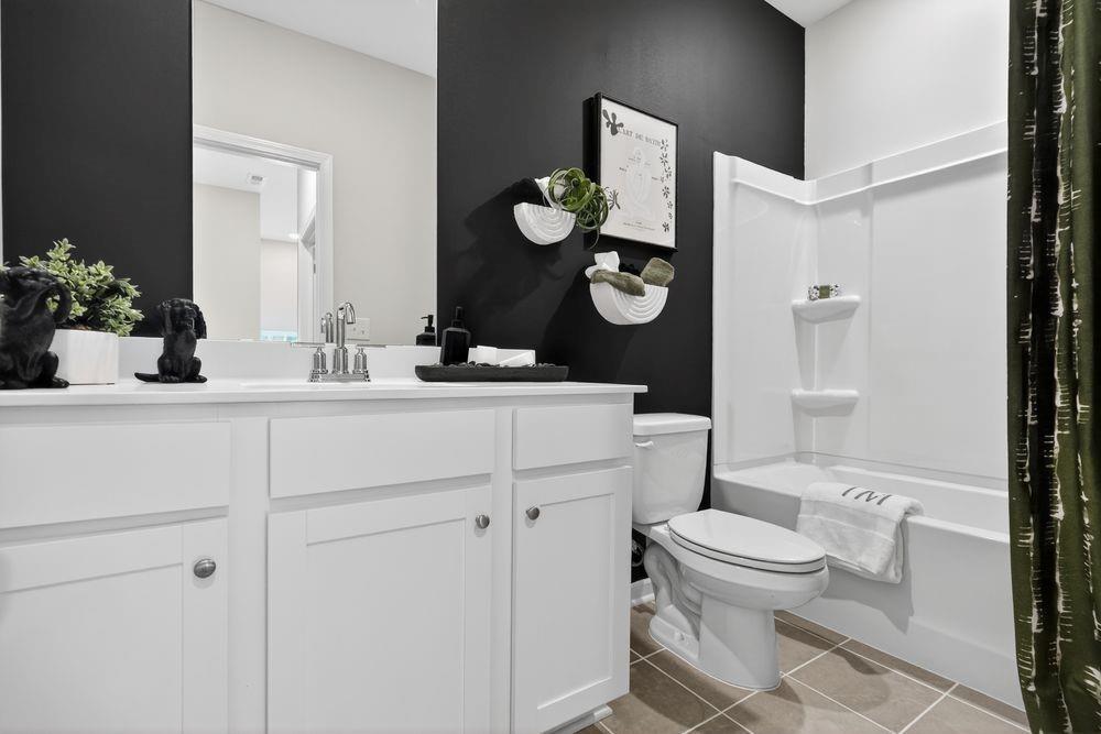747 Meadow Ridge Lane Cumming, GA 30040 - Photo 24 of 41 a bathroom with a toilet sink vanity granite and mirror
