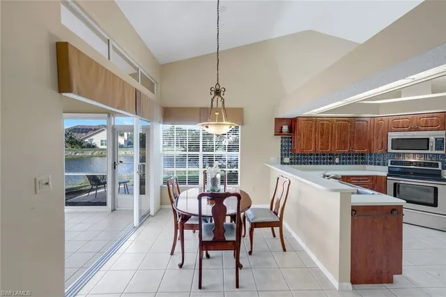 a kitchen with a table chairs and microwave