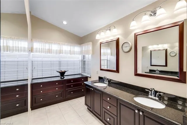 a bathroom with a sink double vanity and a mirror