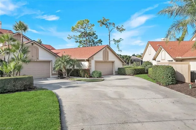 a view of a house with a yard and plants