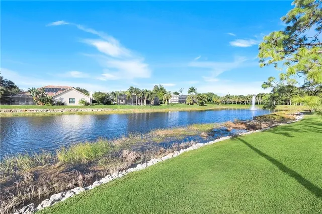 a view of a lake with houses in the back