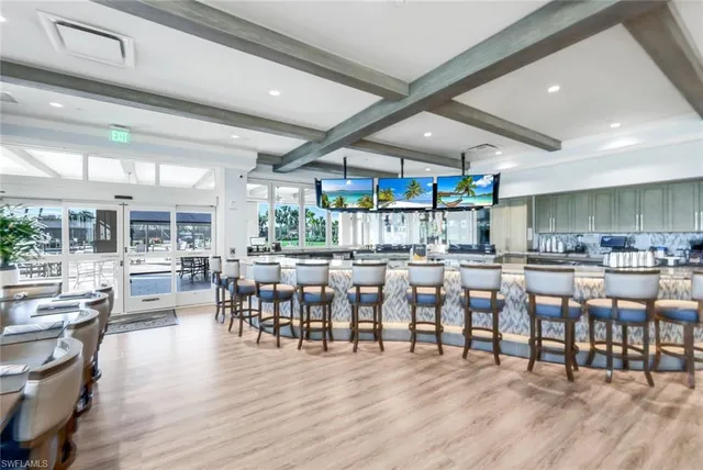 a group of people sitting at kitchen counter top and dining room