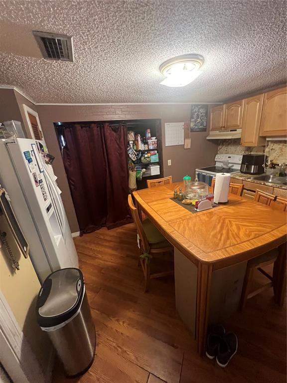 6006 Vel Street Wimauma, FL 33598 - Photo 3 of 17 a kitchen with a table chairs and a wooden floor