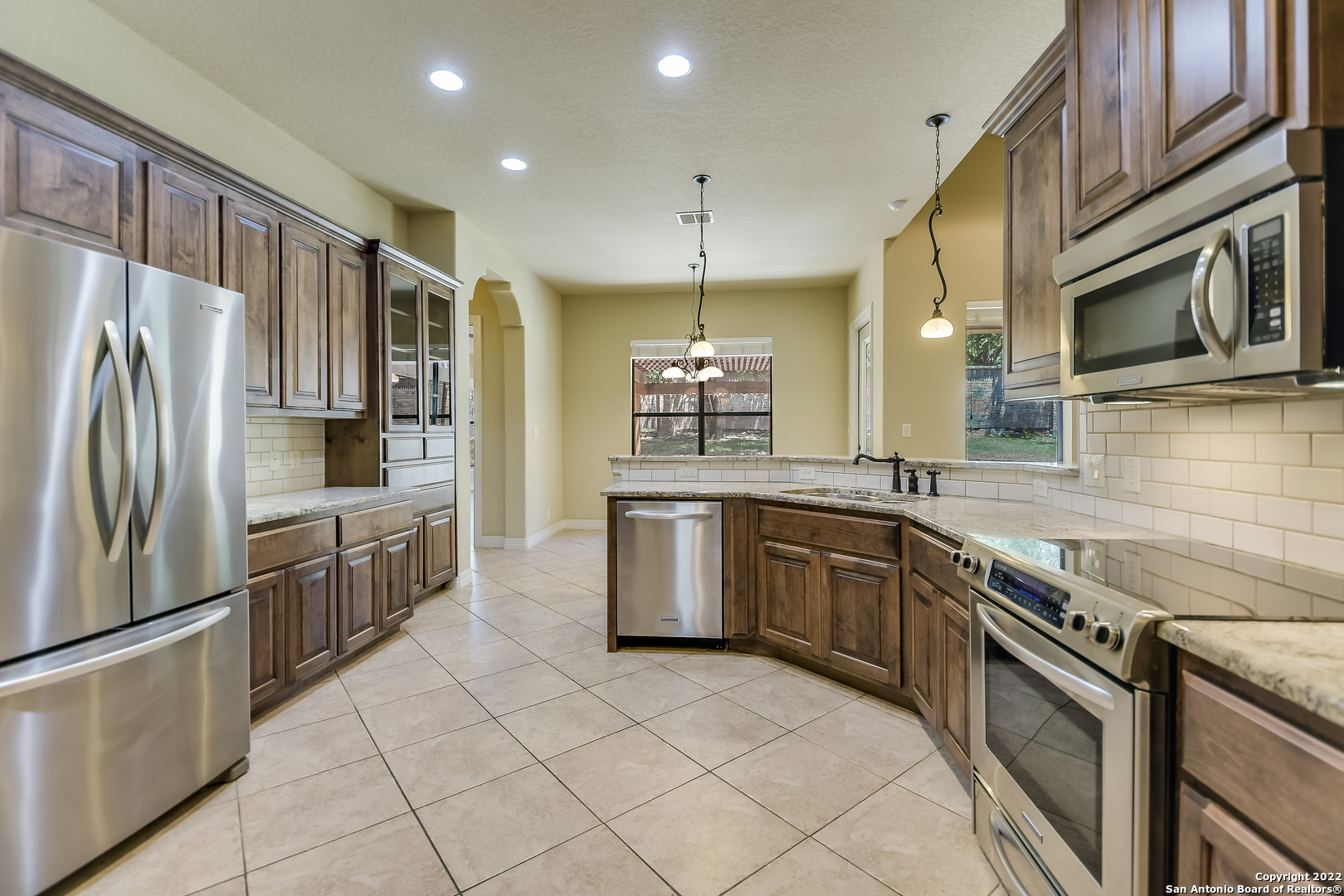 29114 Tivoli Way Boerne, TX 78015 - Photo 11 of 31 a kitchen with stainless steel appliances granite countertop a refrigerator a stove a sink and a microwave