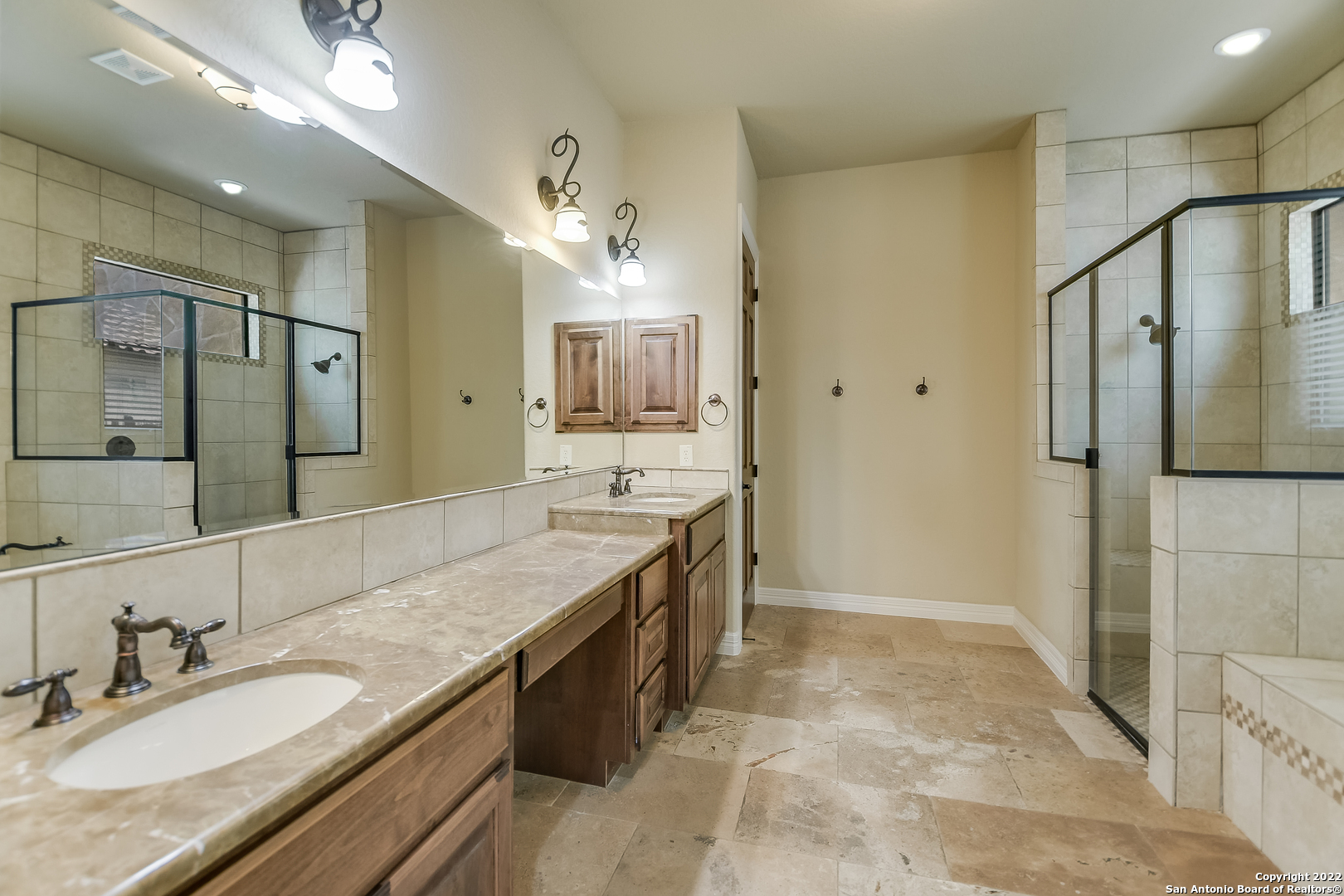 29114 Tivoli Way Boerne, TX 78015 - Photo 15 of 31 a spacious bathroom with a granite countertop sink a mirror and shower
