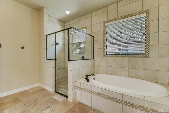 a bathroom with a bathtub and shower