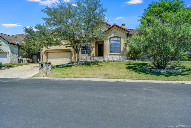 a backyard of a house with yard and outdoor seating