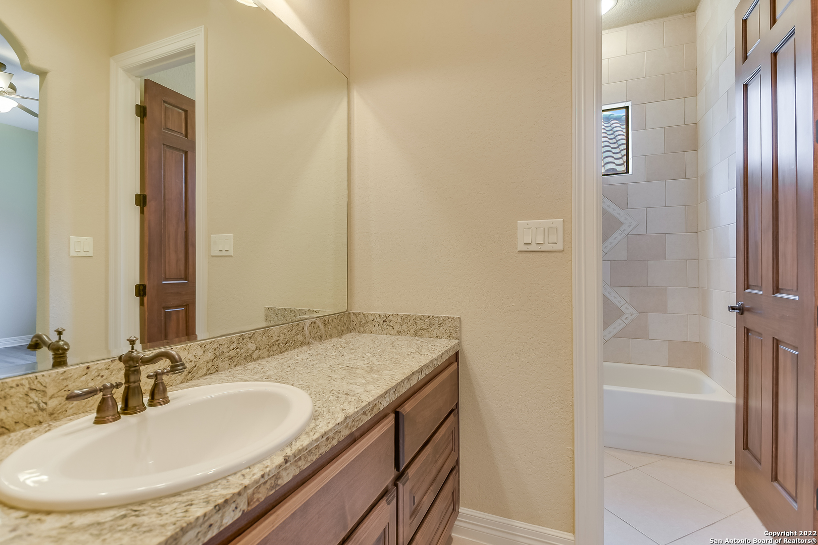 29114 Tivoli Way Boerne, TX 78015 - Photo 22 of 31 a bathroom with a granite countertop sink and a mirror