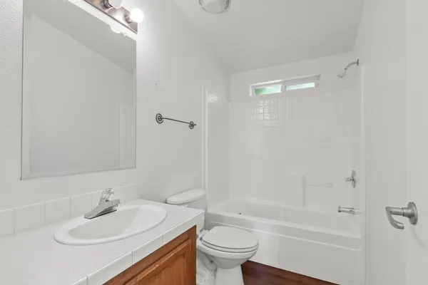 a bathroom with a sink a toilet and a bathtub