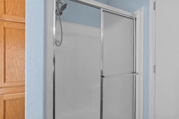 a bathroom with a glass shower door