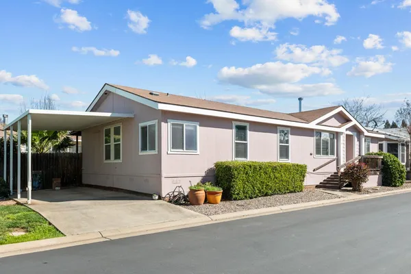 a view of a house next to a yard