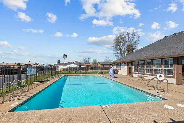 a view of a patio with chairs and a table