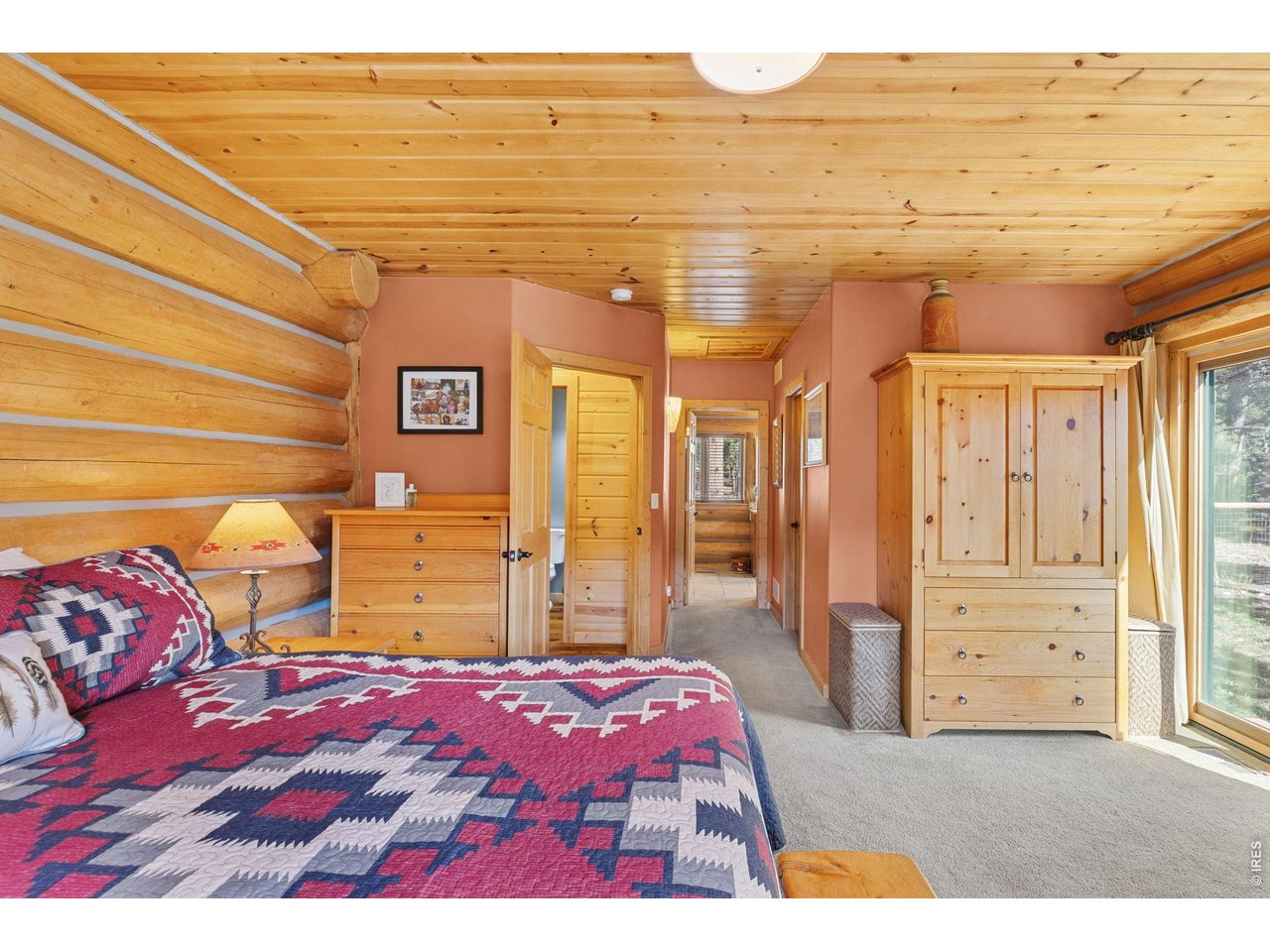 470 Big John Road Lyons, CO 80540 - Photo 19 of 44 a bedroom with a bed and a walk in closet