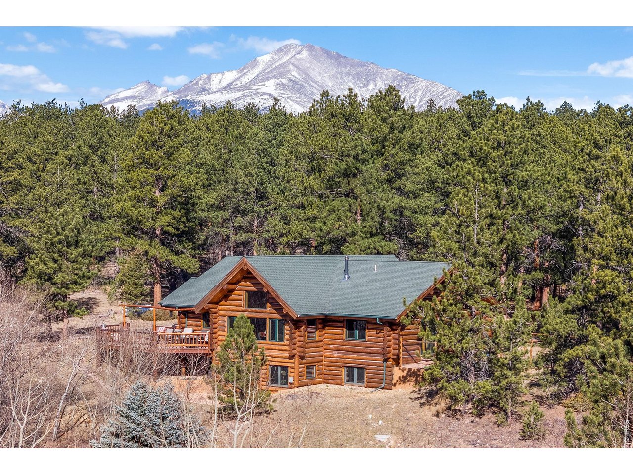 470 Big John Road Lyons, CO 80540 - Photo 37 of 44 a front view of a house with a yard and mountain view in back