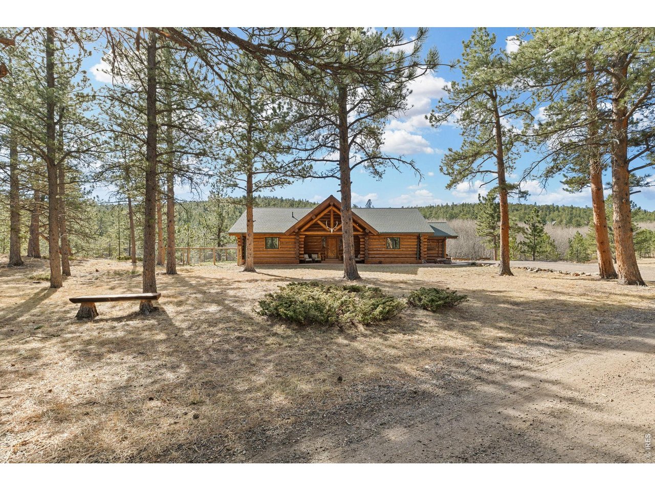 470 Big John Road Lyons, CO 80540 - Photo 43 of 44 a backyard of a house with large trees and outdoor seating