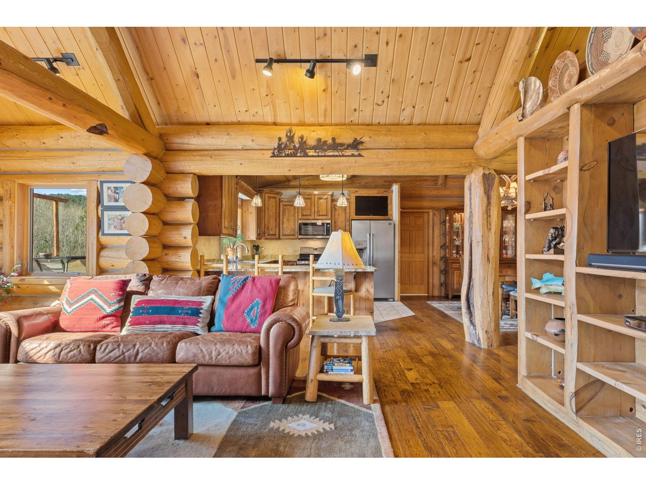 470 Big John Road Lyons, CO 80540 - Photo 10 of 44 a living room with furniture and a chandelier