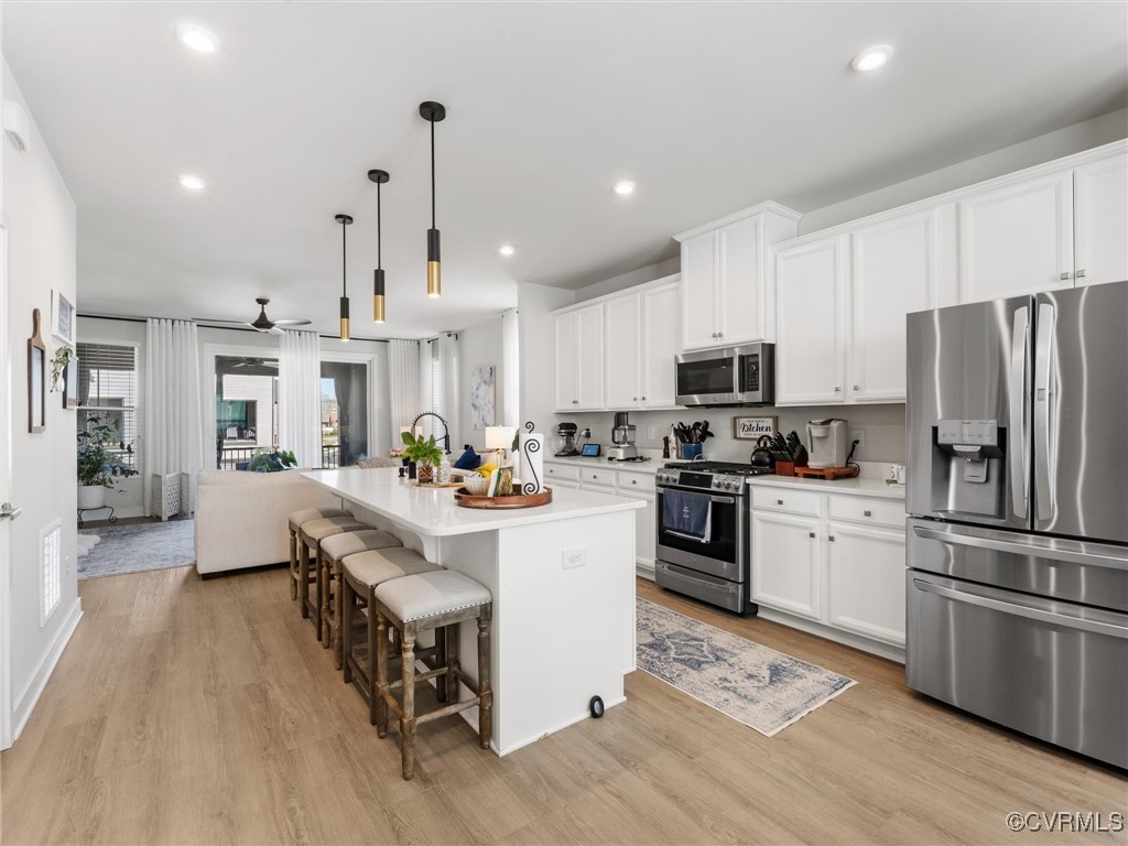 14100 Millpointe Road Midlothian, VA 23114 - Photo 18 of 46 a kitchen with white cabinets stainless steel appliances and center island