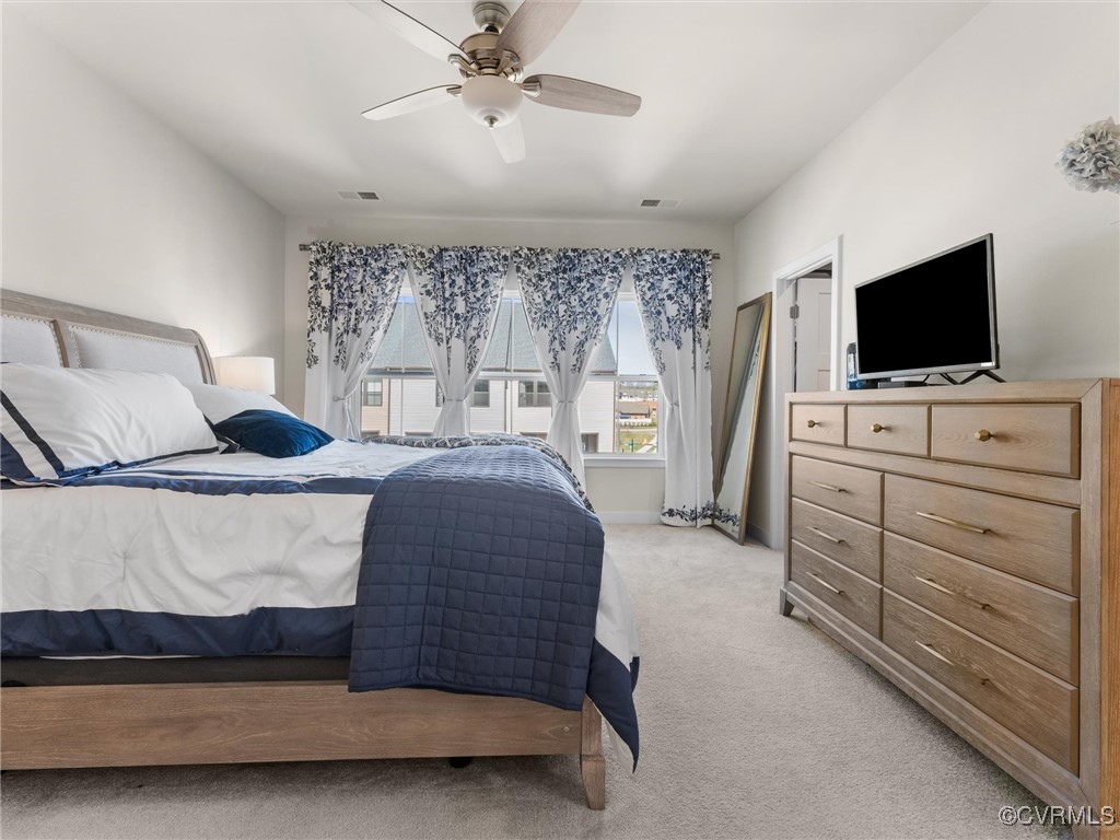 14100 Millpointe Road Midlothian, VA 23114 - Photo 24 of 46 a bedroom with a bed and a flat tv screen on dresser
