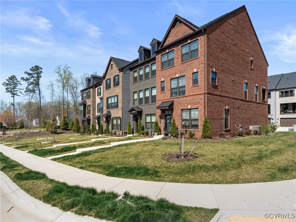 14100 Millpointe Road Midlothian, VA 23114 - Photo 3 of 46 a view of a big building with a yard and plants