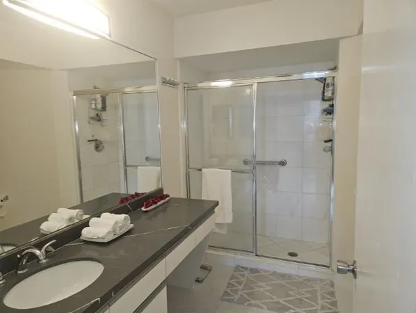 a view of a swimming pool with sitting area and furniture