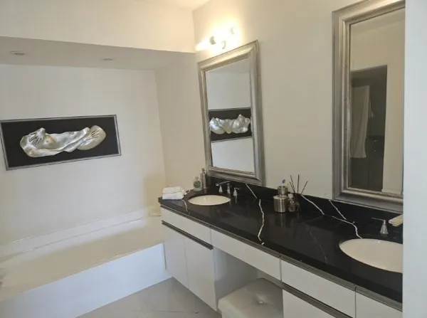 a living room with furniture and wall painting