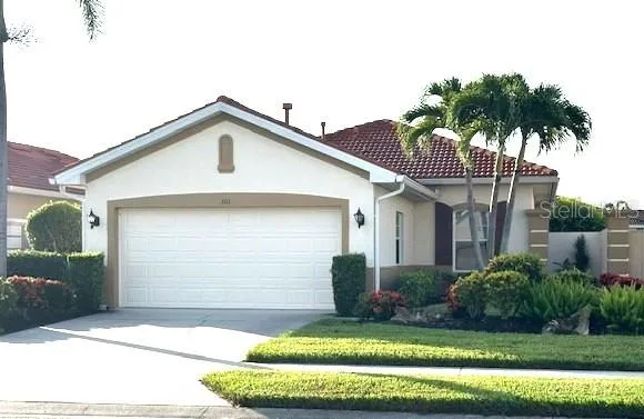 a front view of a house with a garden
