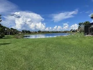 a view of a lake with houses in the background