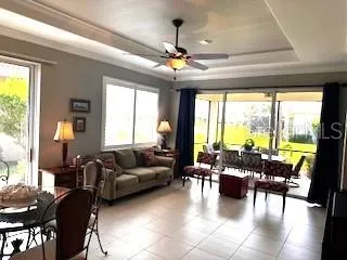 a living room with furniture and floor to ceiling windows