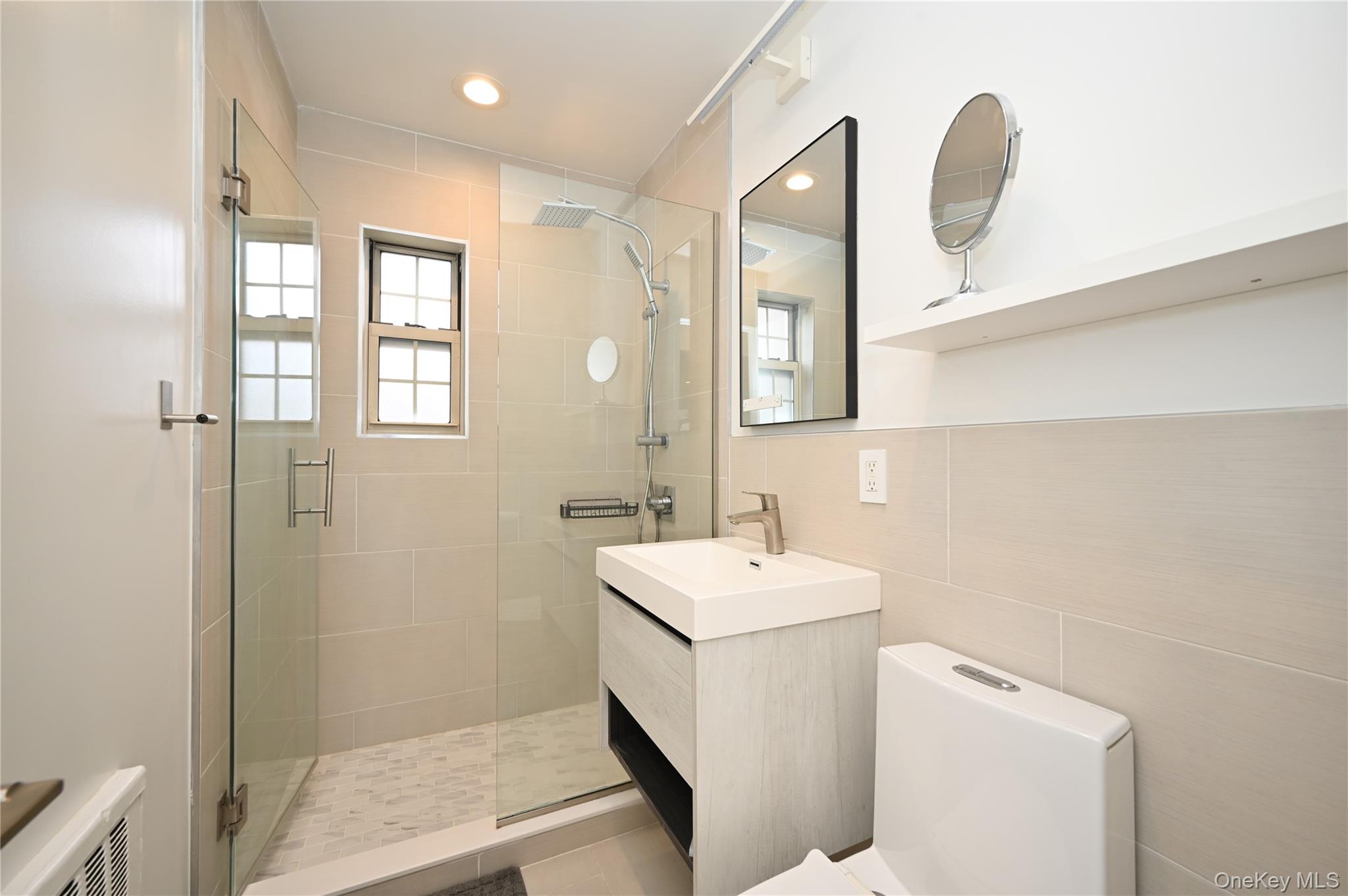 69-25 215th Street, Unit A Queens, NY 11364 - Photo 11 of 17 a bathroom with a sink a toilet and shower